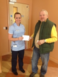 2012 Capt Joey Byrne handing cheque to Oldham cancer unit representative