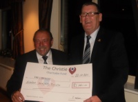 Capt Pete Holden presents cheque to Terry Dean of Christies Charity